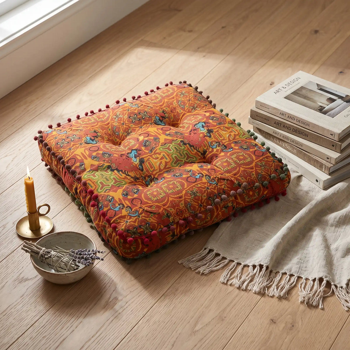 coussin de sol orange avec des motifs multicolores